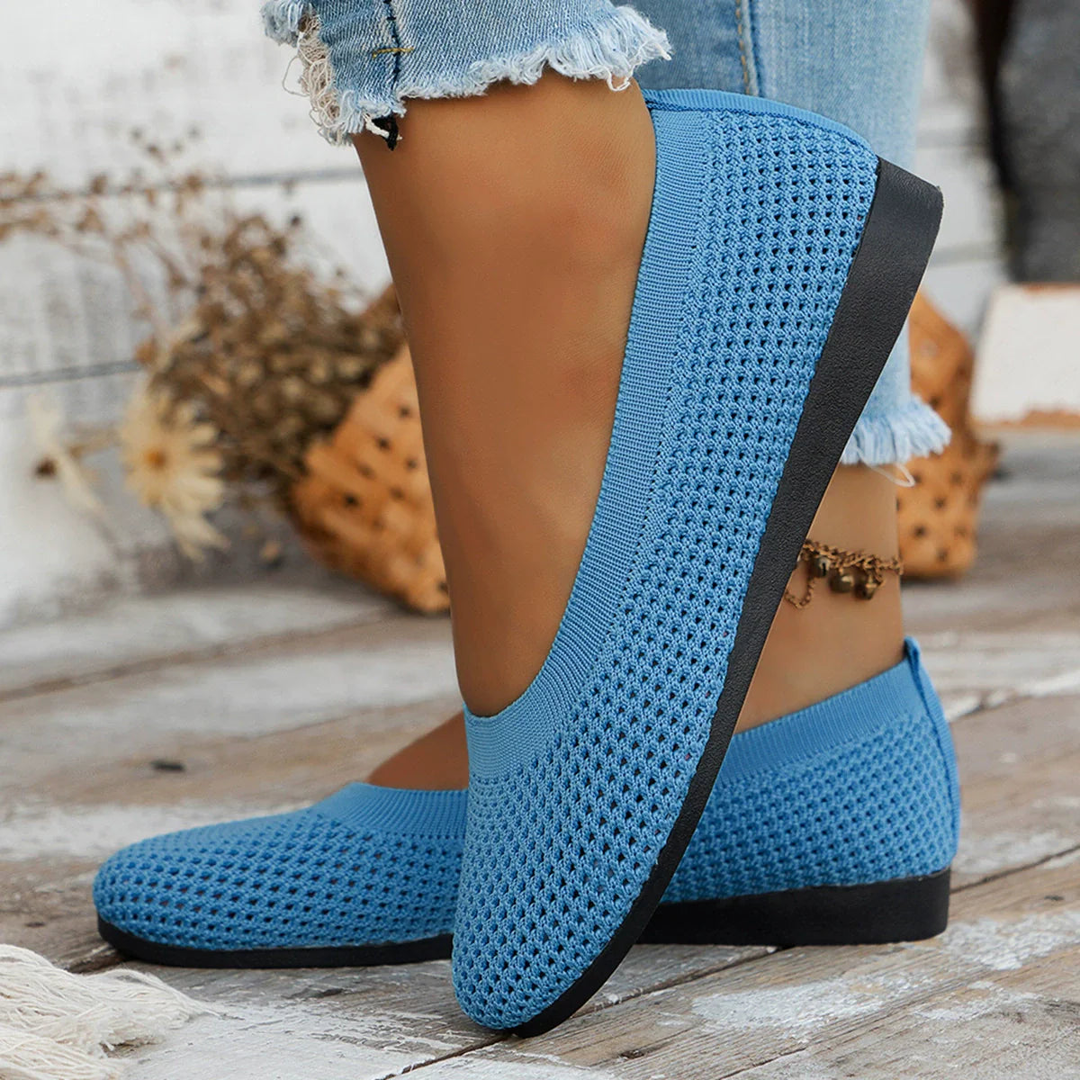 Sky blue breathable knit ballet flats with a flexible sole and perforated texture.