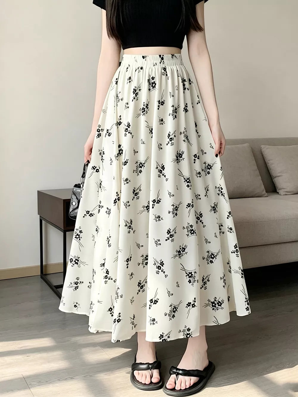 black A-line skirt featuring elastic waist and ditsy floral