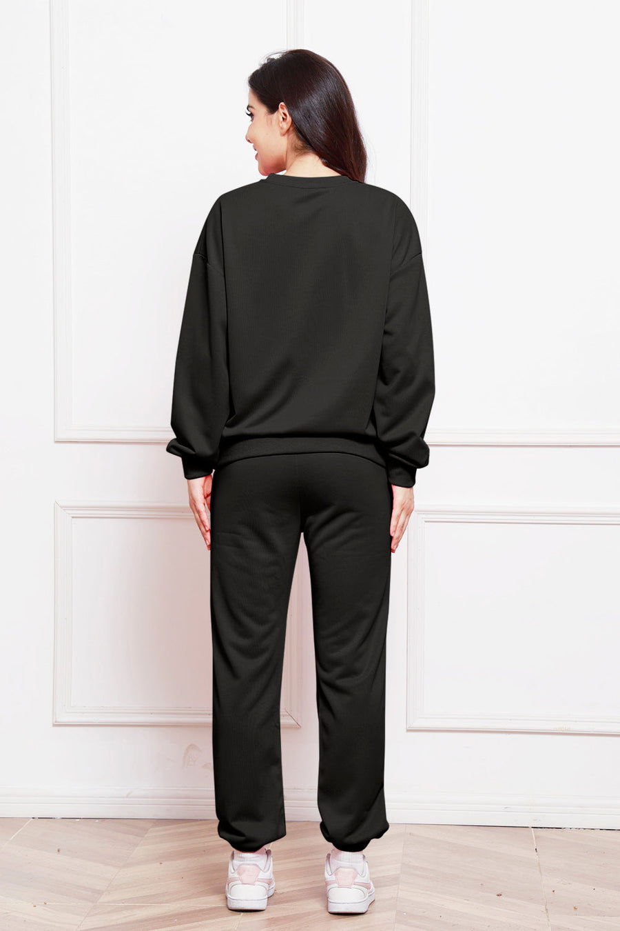 Black relaxed fit loungewear set with crewneck sweatshirt and sweatpants.