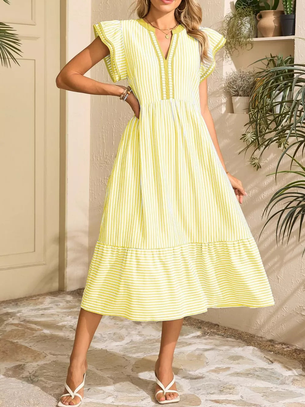 Yellow striped midi dress with V-neck, ruffle sleeves, and tiered hem.