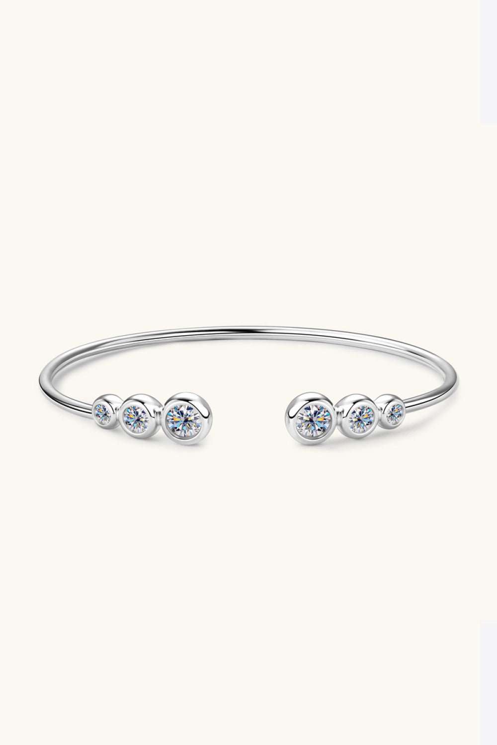 Silver open-ended cuff bracelet with five sparkling moissanite stones.