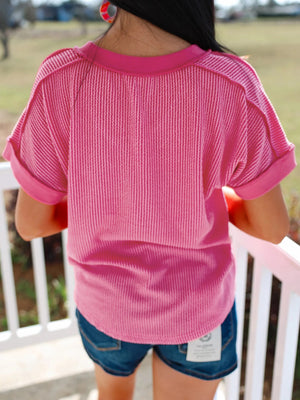 Pink striped v-neck tee with cuffed short sleeves.