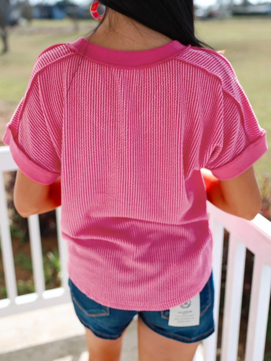 Pink striped v-neck tee with cuffed short sleeves.