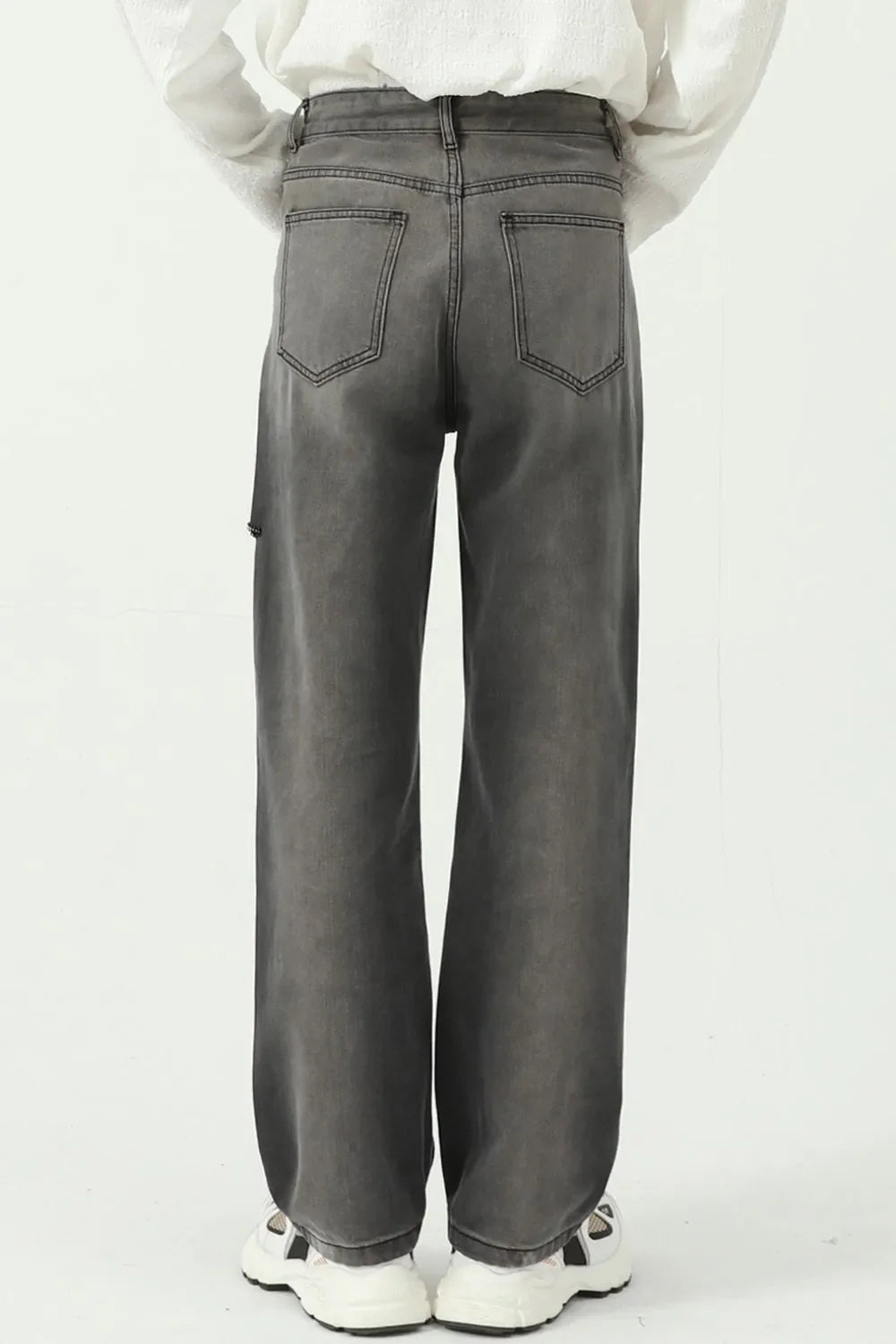 Dark wash denim jeans with a faded look and distressed knee detail.