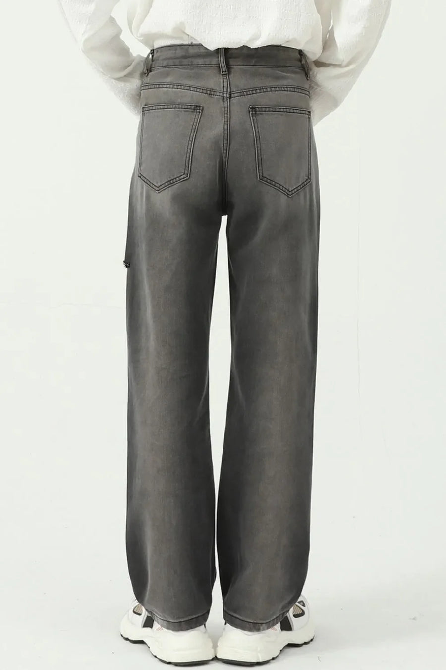 Dark wash denim jeans with a faded look and distressed knee detail.