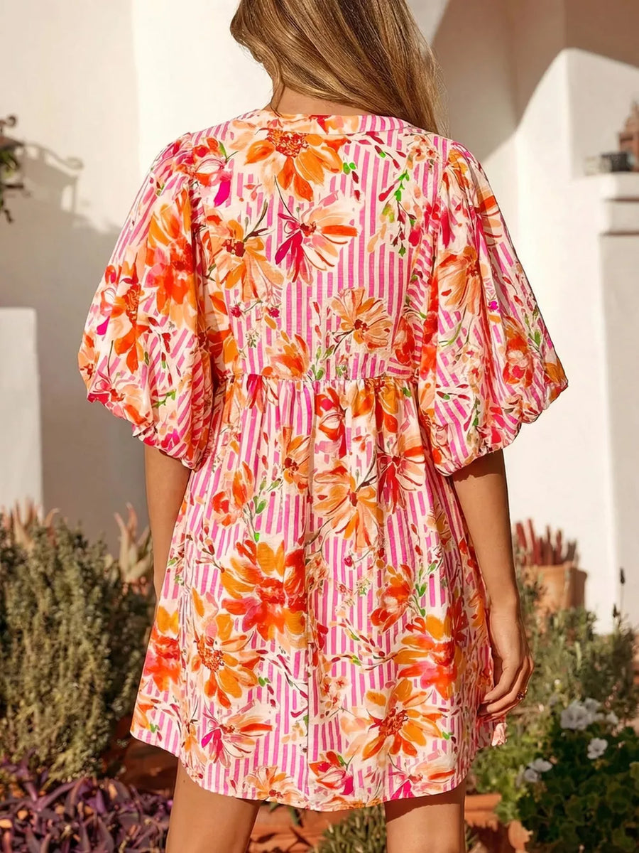 Floral print mini dress with pockets, puff sleeves, and pink stripes.