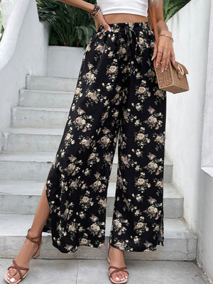 Black floral palazzo trousers with split hems and a drawstring waist.