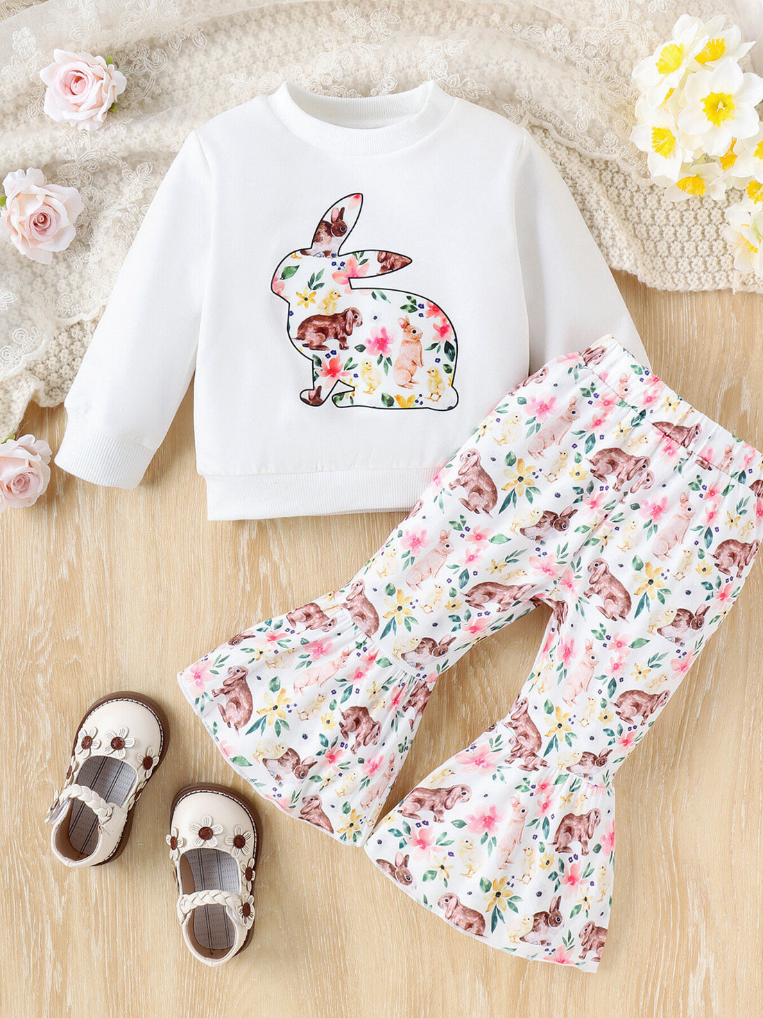White baby crew neck sweatshirt with bunny floral print and matching bell bottom pants.