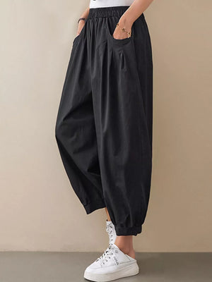 Black relaxed fit harem joggers with elastic waist and pockets.