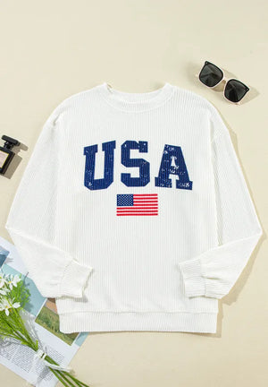 White ribbed knit sweatshirt with blue USA graphic and American flag detail.