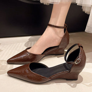 Brown pointed-toe ankle strap wedge shoes with adjustable buckle.