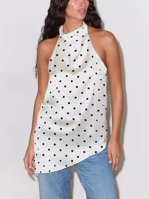 White polka dot halter top with a cowl neck and sleeveless design.