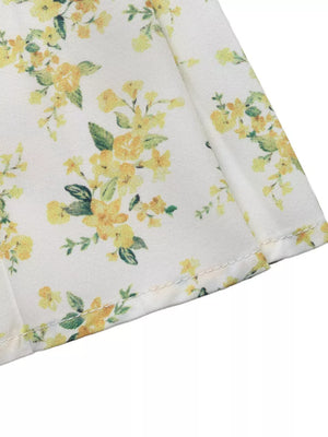 Charming floral mini dress with puff sleeves in white with yellow floral print.