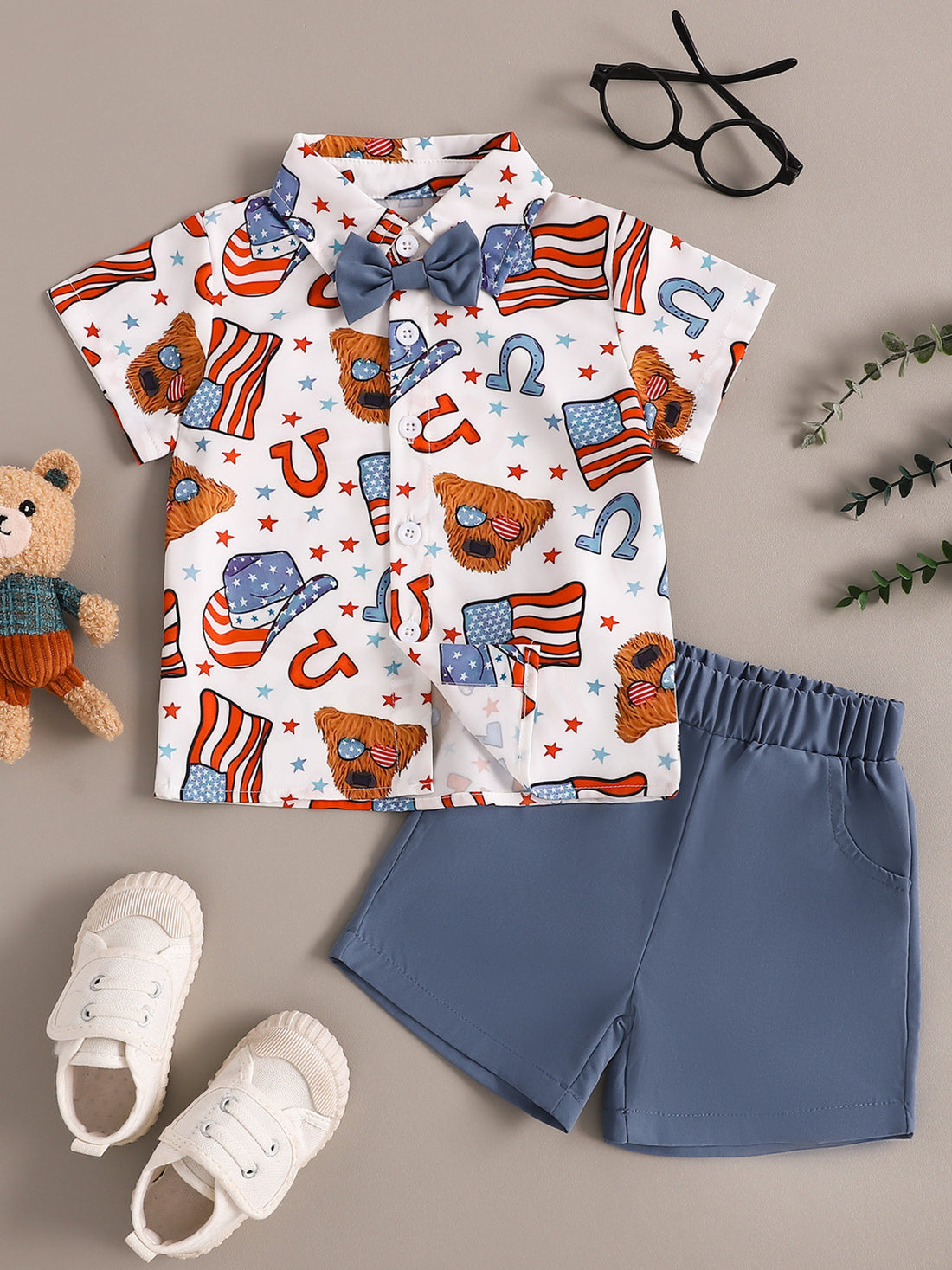 Toddler patriotic bow tie shirt set with American flag and cowboy hat print, blue shorts.