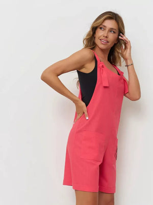 Cotton tie-strap romper in red with pockets and rolled hem.