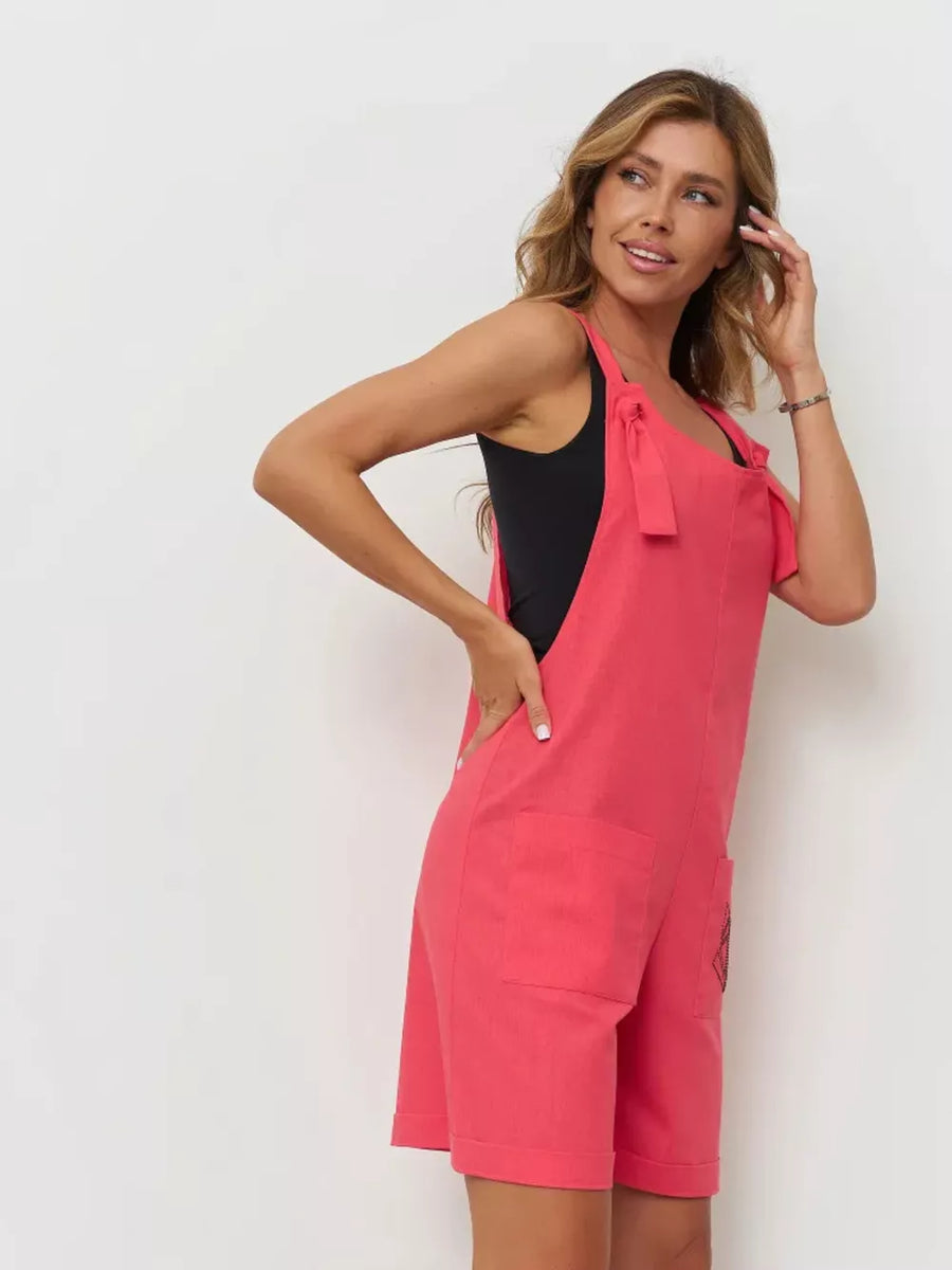 Cotton tie-strap romper in red with pockets and rolled hem.