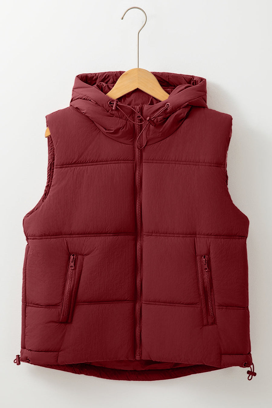 Burgundy quilted hooded puffer vest with zip pockets and adjustable drawcord hem.