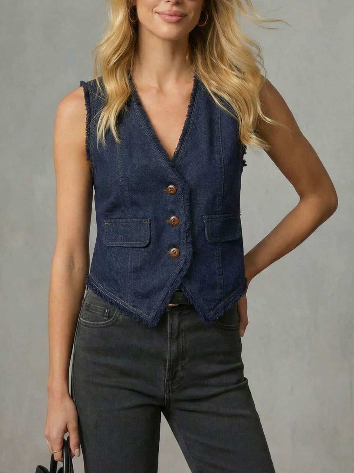 Dark navy denim vest with frayed hem, button front, and chest pockets.