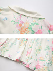 Maternity midi dress in apricot with floral print and ruffle sleeves.