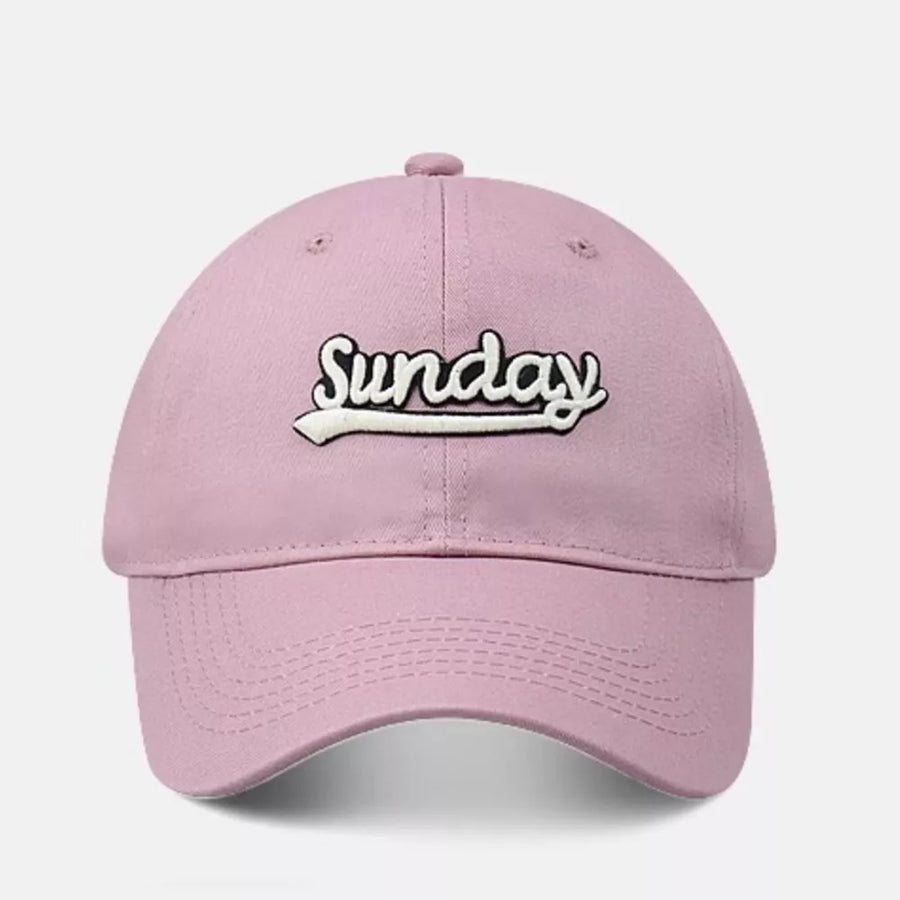 Pink baseball cap with embroidered "Sunday" text and curved brim.