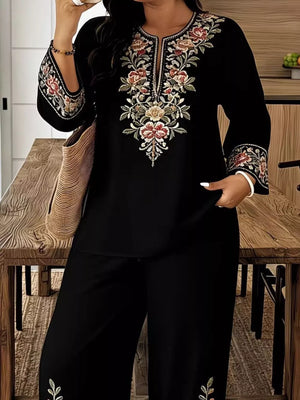 Black embroidered top with floral detail and matching wide-leg pants.