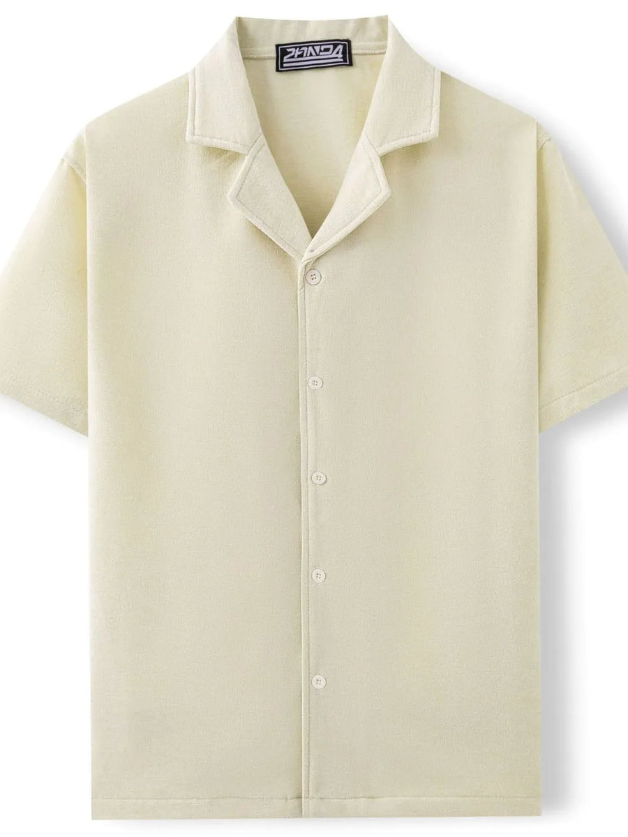 Textured velour camp collar shirt in ivory with button front and short sleeves.