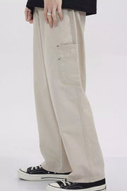 Relaxed fit beige cargo sweatpants with a utility pocket detail.