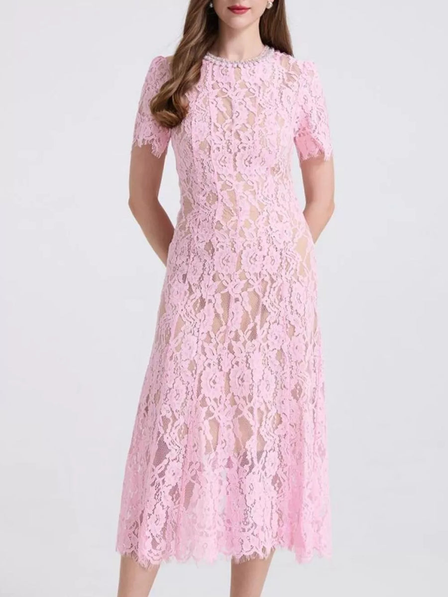 Pink lace midi dress with pearl-embellished neckline and short sleeves.