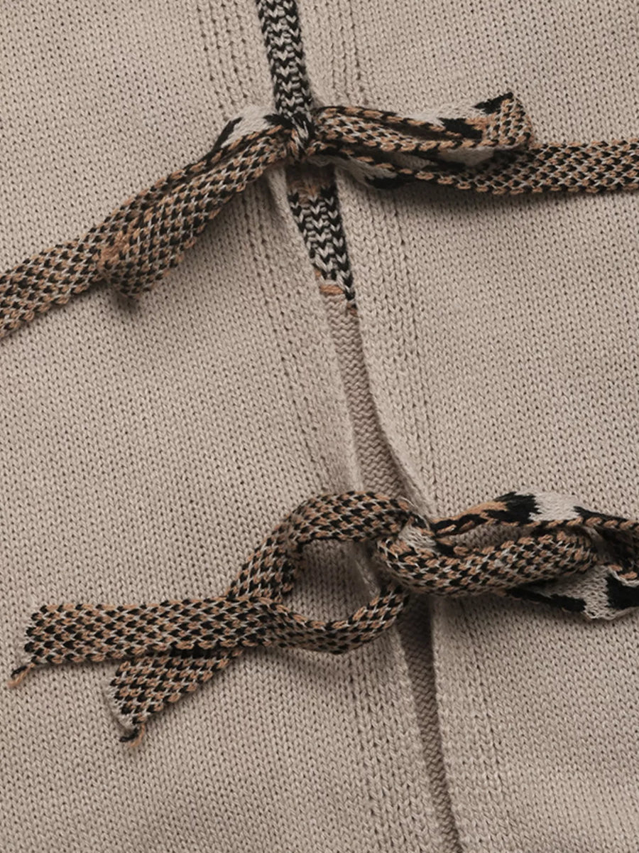 Knit cardigan in gray apricot with patterned tie details at the neckline and waist.
