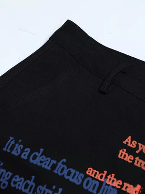 Black cargo pants with blue and orange text print detail