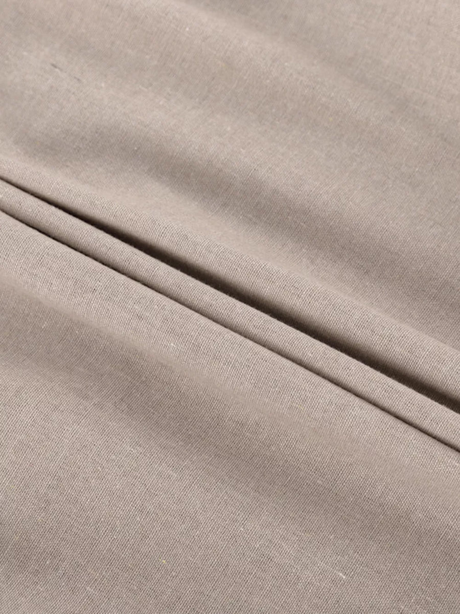 Textured beige linen fabric with soft folds
