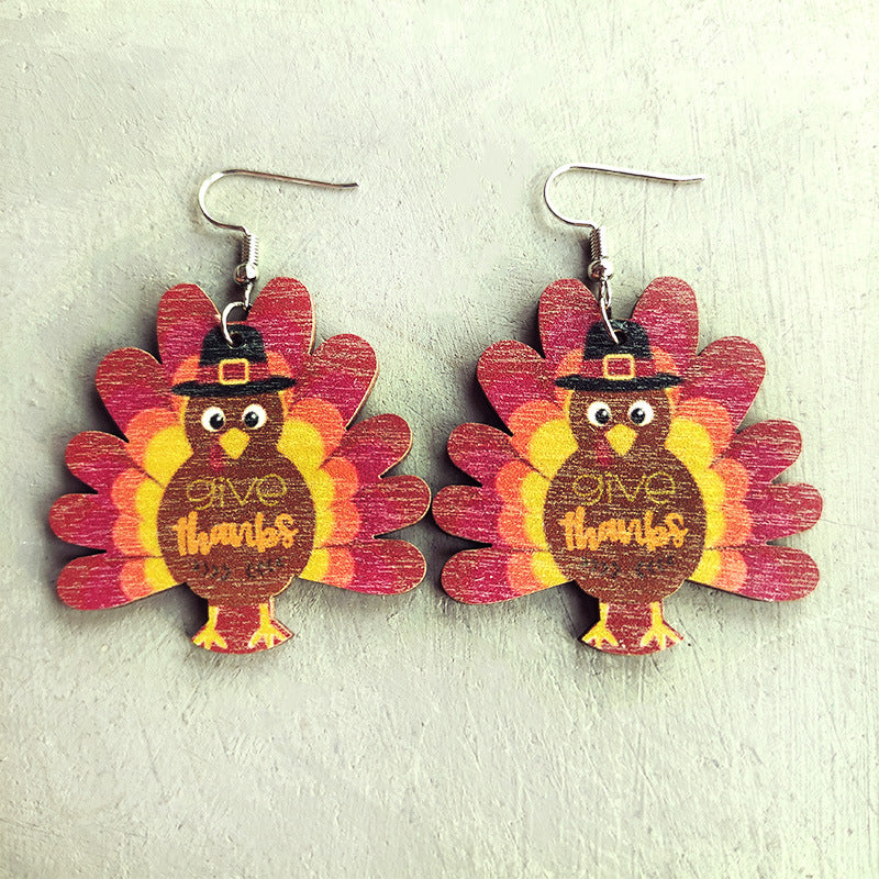 Thanksgiving turkey dangle earrings with colorful feathers and "give thanks" text.