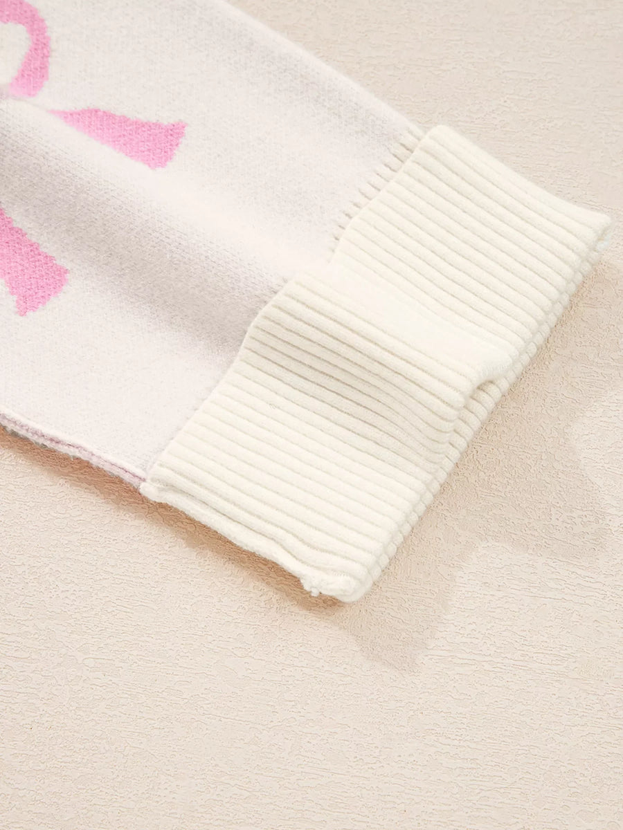 Bow print drop shoulder sweater in beige acrylic blend with ribbed cuffs.