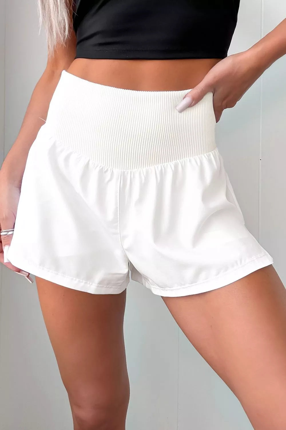 White ribbed-waist relaxed fit shorts with a high rise and a-line cut.