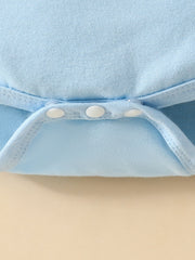 Light blue baby bodysuit detail showing white snap closures and ribbed trim.