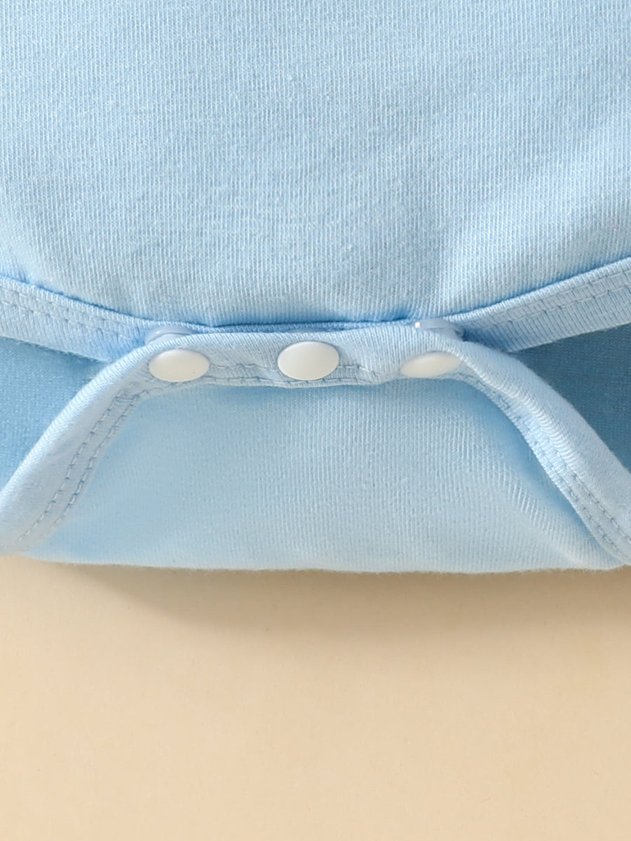 Light blue baby bodysuit detail showing white snap closures and ribbed trim.