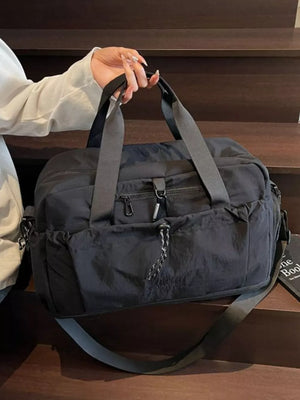 Black lightweight travel duffel bag with multiple zippered pockets and adjustable straps.