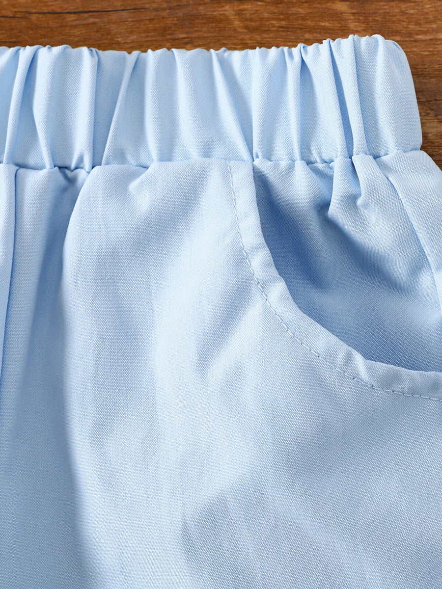 Light blue cotton baby shorts with elastic waistband and pocket detail.