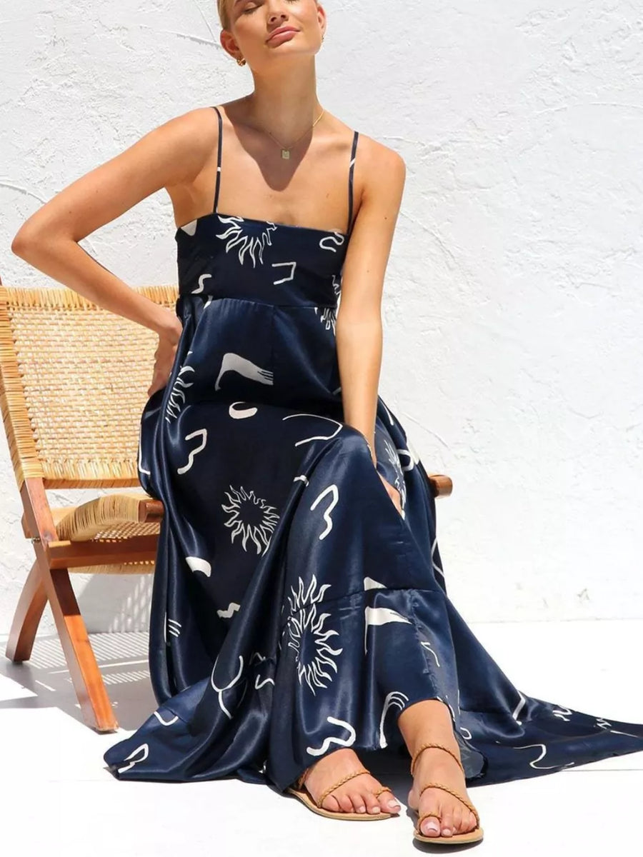 Dark Navy spaghetti strap maxi dress with abstract sun print and square neckline.