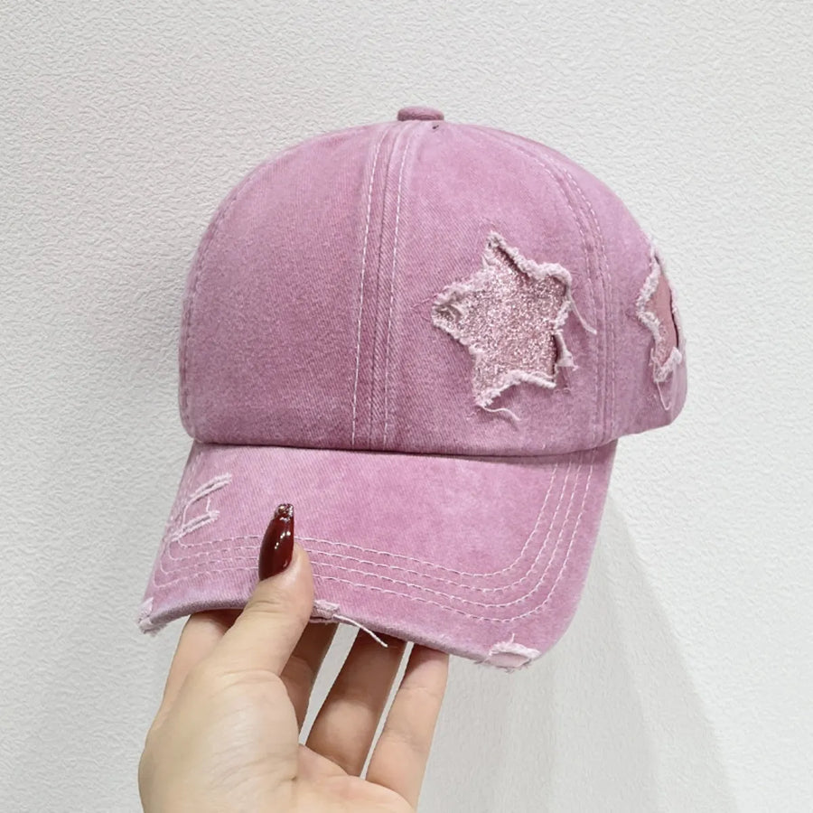 Stellar snapback cap in dusty pink with distressed star details and frayed brim.