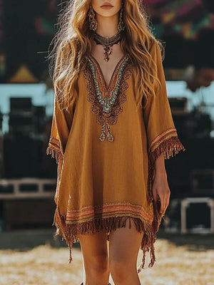 Embroidered bohemian mini dress in mustard yellow with fringed hem and sleeves, featuring a deep V-neckline with colorful