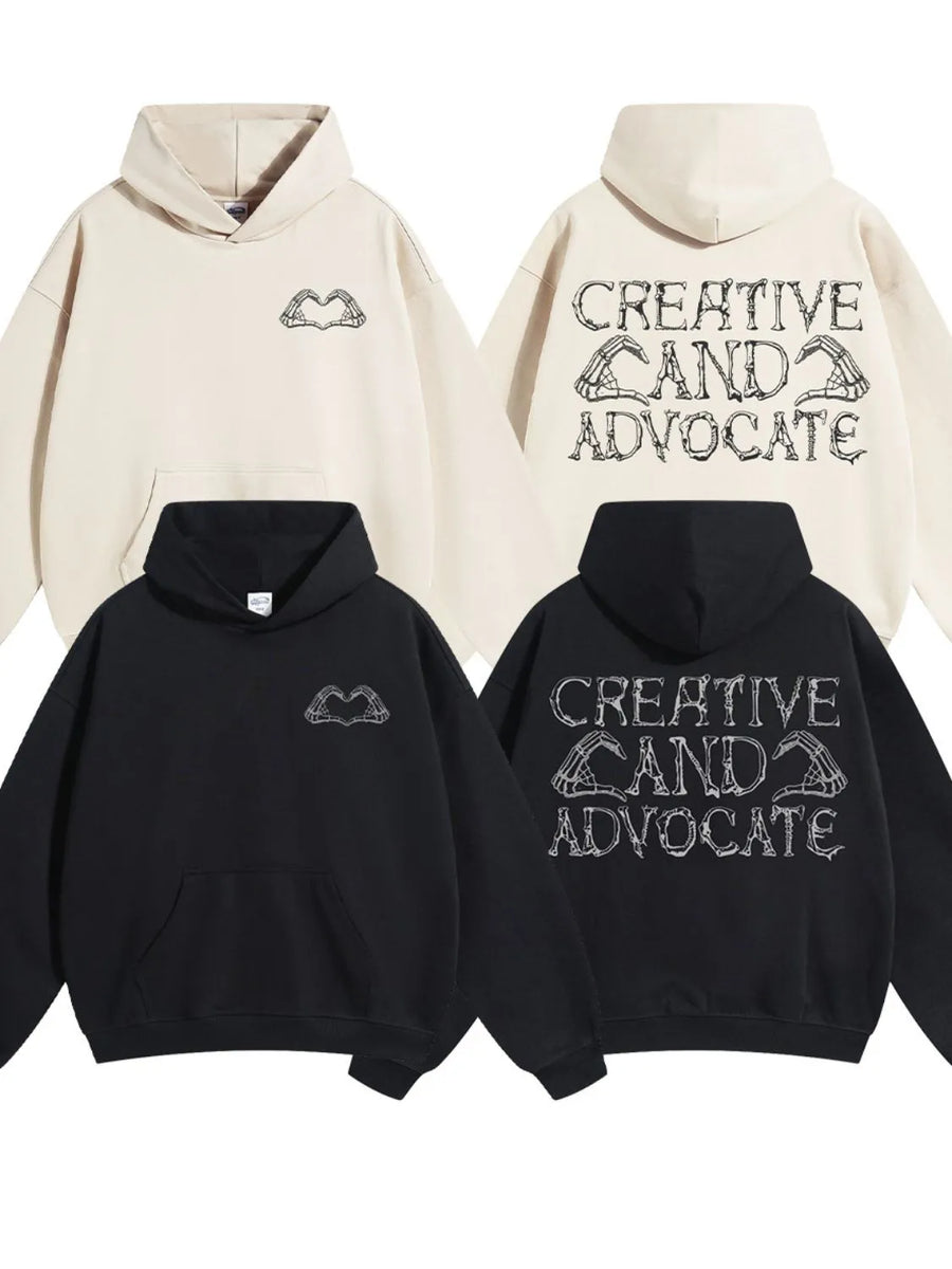 Black and beige oversized hoodies with embroidered skeleton hands forming a heart on the front and text on the back.