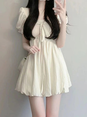 mini dress in cream featuring bow and A-line fit
