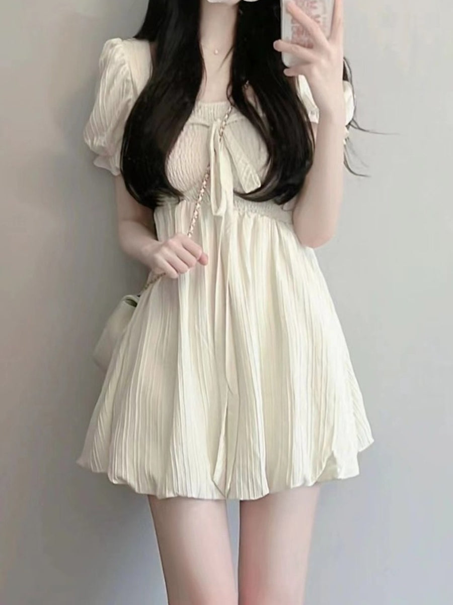 mini dress in cream featuring bow and A-line fit