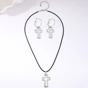 Silver cross pendant necklace and hoop earrings set with black cord chain.