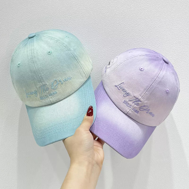 Gradient embroidered cotton baseball caps in light purple and cyan with embroidered text