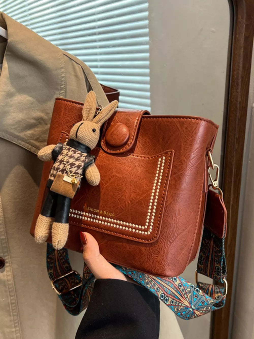 crossbody bag in cognac featuring adjustable strap and boxy fit