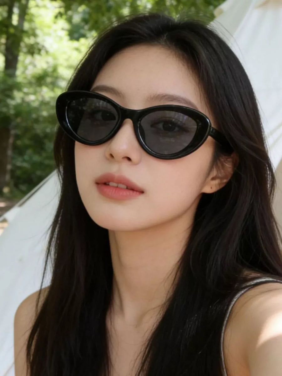 Black cat eye sunglasses with UV protection on a woman.
