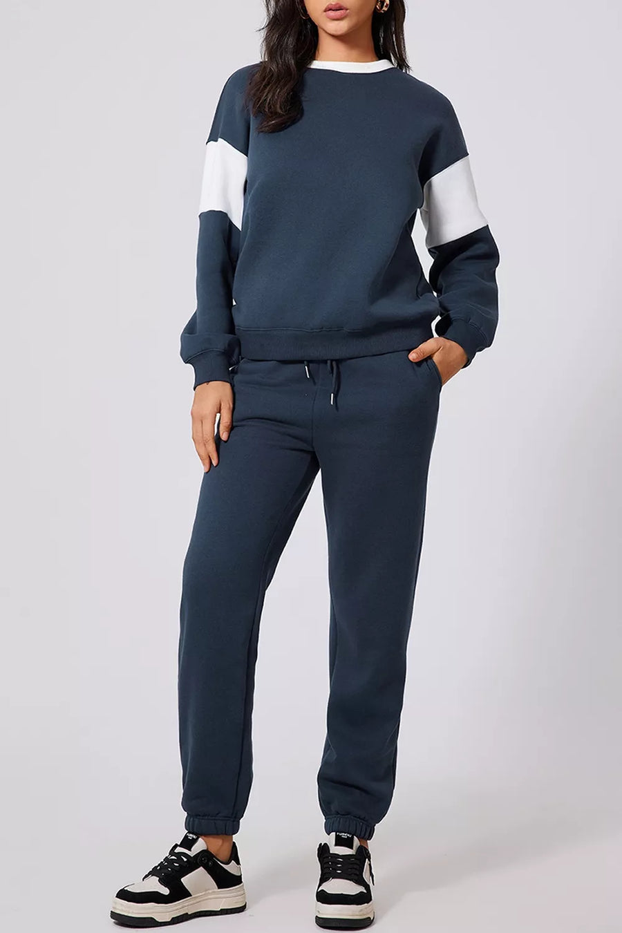 Navy oversized active set sweatshirt with white colorblock sleeves and matching joggers.