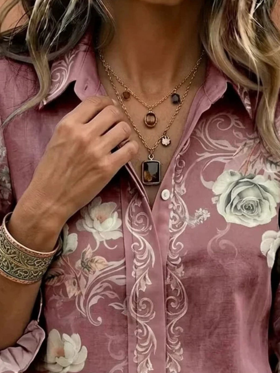 cream button-down shirt featuring button cuffs and floral